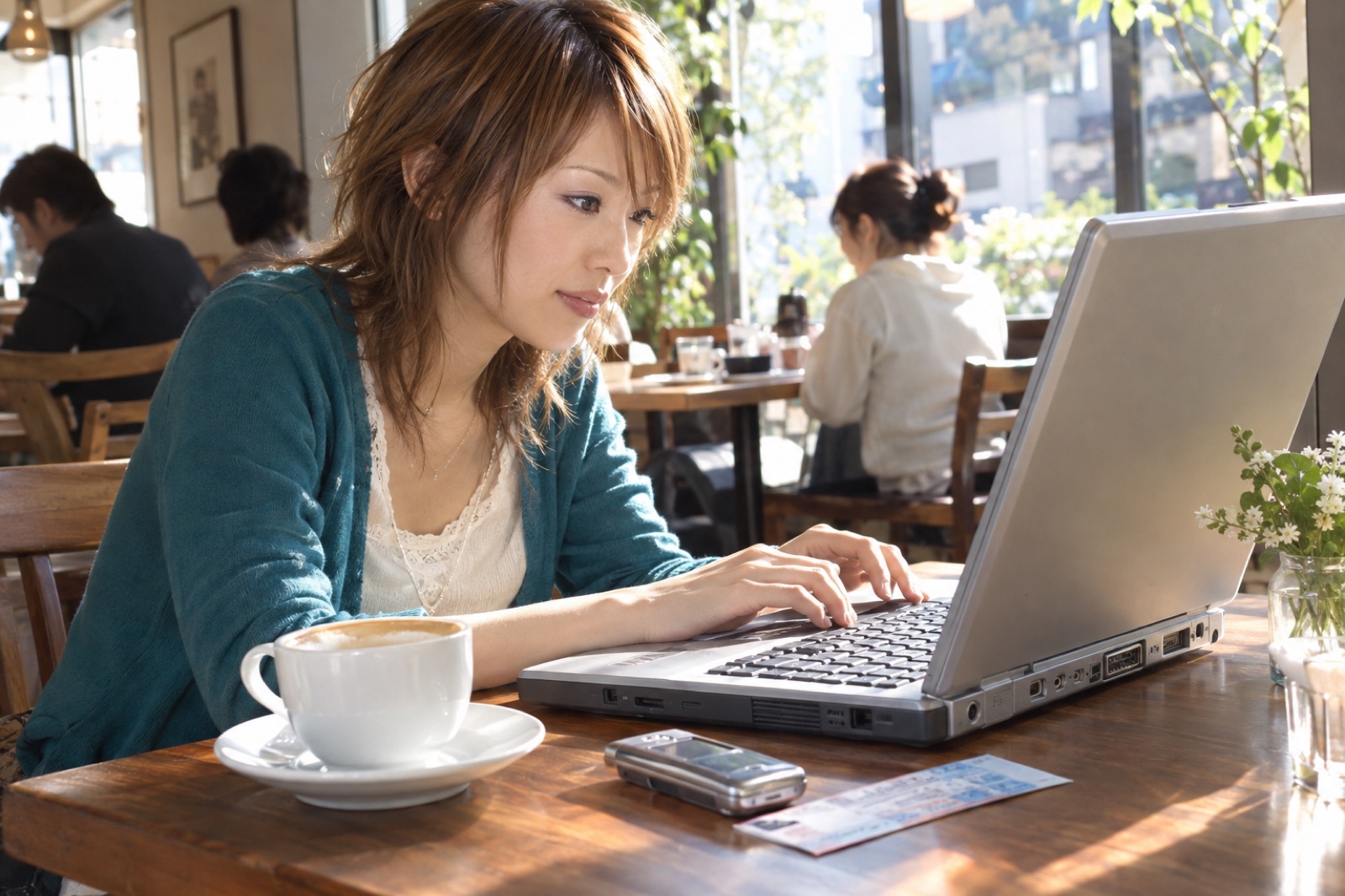 カフェのノートパソコンでファン同士の交流を楽しむ2004年の女性